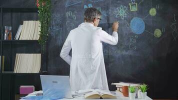 Scientist drawing DNA helix on blackboard. video