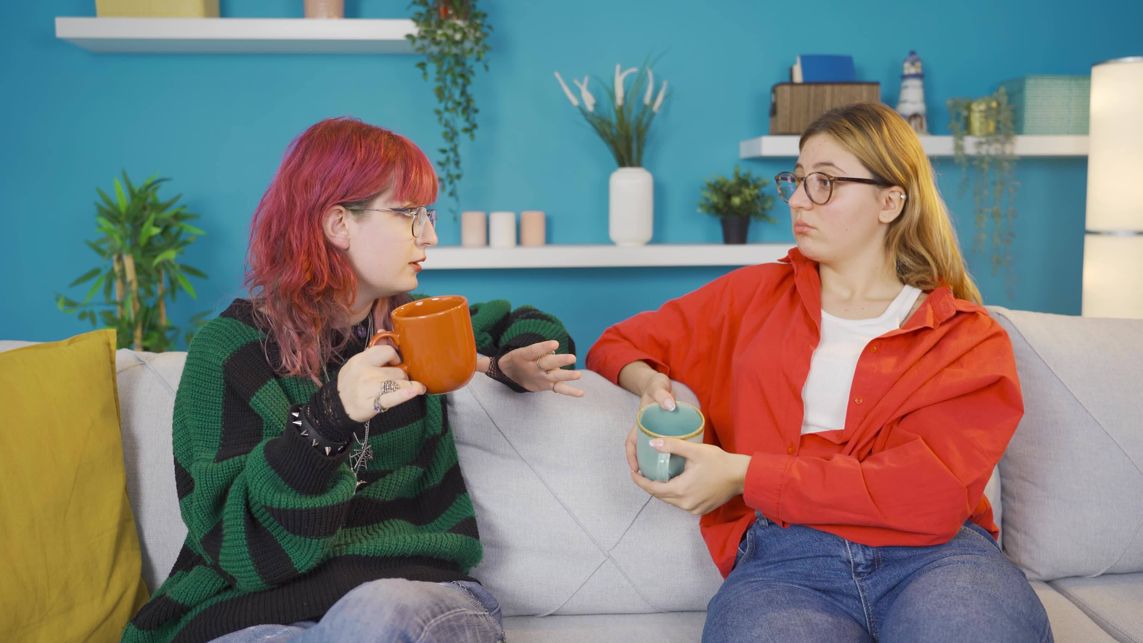 friends-are-arguing-while-drinking-coffee-together-at-home-there-is-a