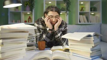 Thoughtful young student reading a book, studying. video