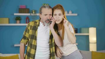 Father and daughter rejoice when they receive the good news over the phone. video