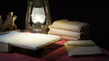 Historical period book in the light of kerosene lamp. video