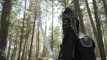 A soldier with a sword in his hand and a helmet on his face. video