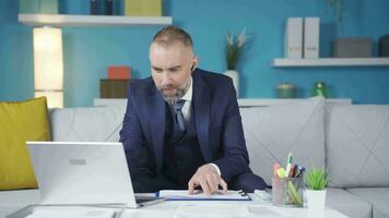 The businessman in a suit is frustrated by what he sees on the laptop. video