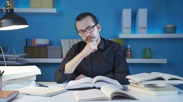 Thoughtful historian man looking at books, researching. video