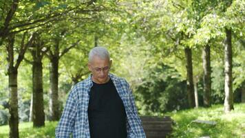 Depressed man goes for a walk in the park. video