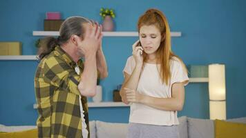 Father and daughter get upset when they get bad news on the phone. video