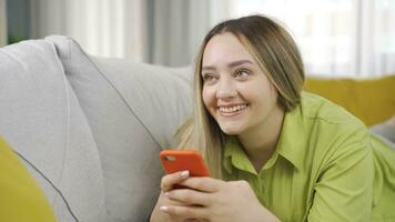 Happy and happy texting young woman. video