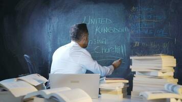 The historian man writing Winston Churchill on the blackboard. video