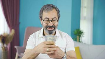 Middle-aged man with money in hand thoughtful. video