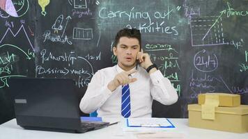 Businessman writes on blackboard to carry out activity and feels nervous. video