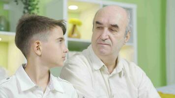 The old man and the boy look at each other. Emotional expression. video