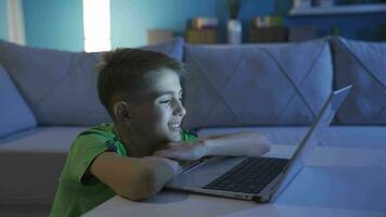 Little boy looking very closely at computer screen. video