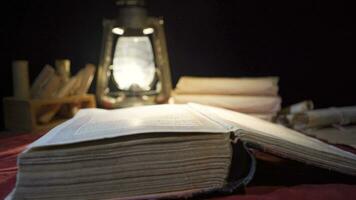 Worn history book of ancient times. Reading by kerosene lamp. video