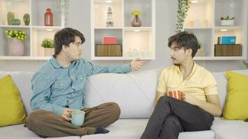 Friends are arguing while drinking coffee together at home, there is a clash of ideas. video