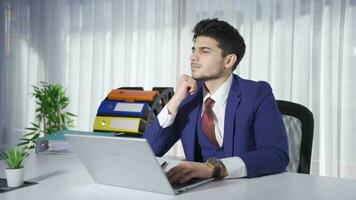 Successful young businessman working on laptop in his office rejoices, good news makes him happy. video