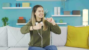 Young girl listening to fun music is dancing and feeling happy. video
