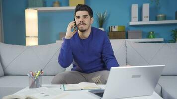 Depressed young man talking on the phone angry and aggressive. video