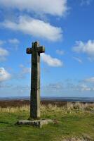 Memorial Stone Cross Waymarker on the Moors in England photo