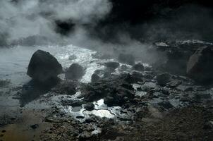 Bubbling Mud and Steam Rising off of Landscape photo