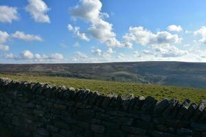 Stone Wall Along a Grass Pasture and Rolling Hills photo