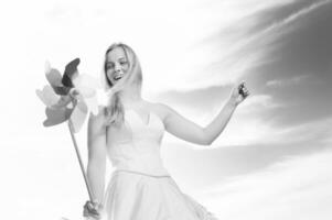 Beautiful bride with pinwheel black and white photo