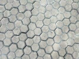 Pavement hexagonal stone background. Hexagonal paving cobble texture laid on city street photo