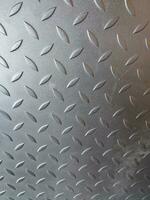 Seamless Metal Floor Slab With Diamond Pattern. Black metal background or black steel surface with natural light photo