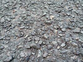 asphalt rough and rocky grunge surface, texture background, gray paved road photo