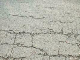 paved and cracked road texture or background photo