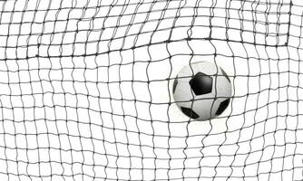 The soccer ball goes into the net and scores a goal. On a white background. photo