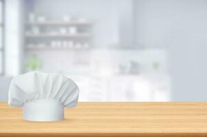 White chef's hat on empty wooden table in the kitchen photo