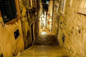 a narrow walkway with stone steps photo