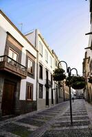 a stone street with a few buildings photo