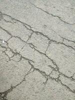 paved and cracked road texture or background photo