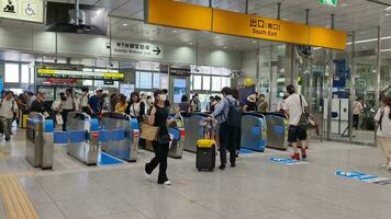 Osaka, Japan on September 29, 2023. Train passengers at Shin Osaka Station passing through the ticket gate. Several people were seen in a rush to board the Shinkansen bullet train or JR trains video