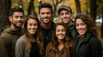 Portrait of group of six friends smiling at the camera in the park. photo