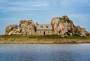 Quaint Seaside Cottage Amidst Brittany's Rocky Shores, France photo