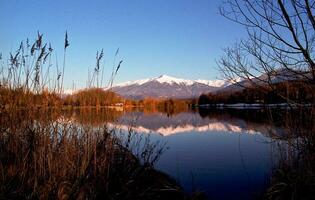 Serene Beauty Blue Lake in Savoie with Snow Capped Mountains photo