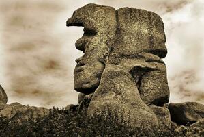 Sculpted Stone Sepia Head Shaped Granite Rock in Trebeurden, Bretagne, France photo