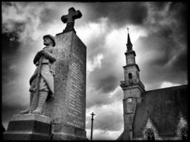 Monument to the Fallen in Tonquedec   Dramatic Black and White Photo of Brittany with Church in the Background