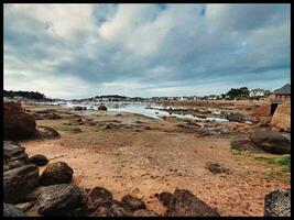 Breton Coastal Beauty Expansive View of Rocky Shoreline and Sea near Perros Guirec photo