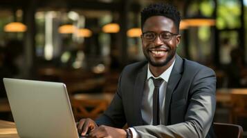 Cheerful african american businessman, accountant or auditor working on laptop. photo