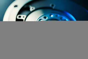 a close up of a hard drive with a blue background. AI-Generated photo