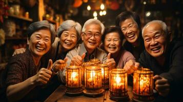 Happy Thanksgiving Day Group of asian senior friends holding candles and showing thumbs up. photo
