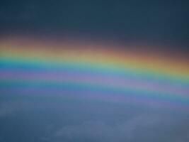 View of a rainbow in a cloudy sky. Double rainbows are a rare phenomenon. photo