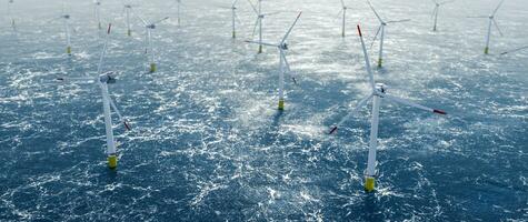 Offshore wind power and energy farm with many wind turbines on the ocean photo