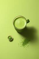 Top view match milk drink in cup with powder on solid green background. Organic powered tea trend from Japan. . photo
