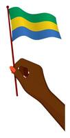 Female hand gently holds small flag of Gabon. Holiday design element. Cartoon vector on white background