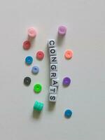 Congratulations greeting text using alphabet beads photo