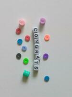 Congratulations greeting text using alphabet beads photo